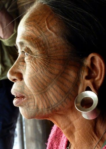 An ethnic minority Chin woman, bearing a facial tattoo, is pictured in Panmaung Village, in Myanmar's remote northwest. The ritual was officially banned by the then socialist regime in the 1960s, and the tattoos became increasingly rare as Christian missionaries converted the previously animist communities, according to a local pastor