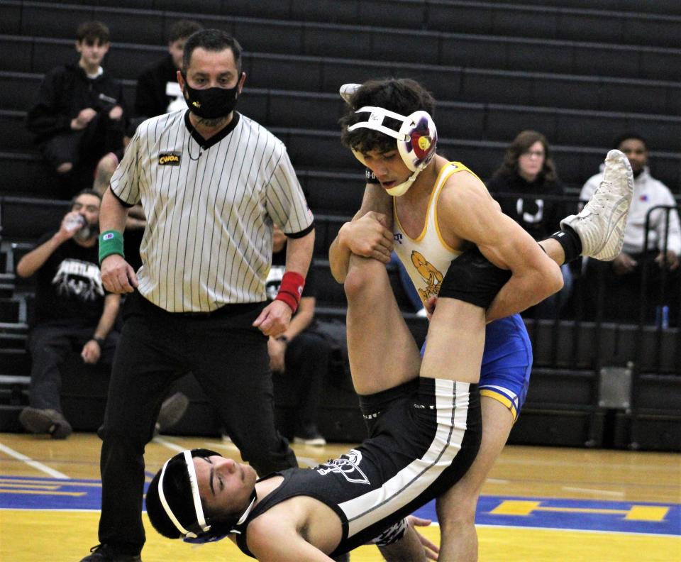 Dolores Huerta's AJ Jaramillo lifts his opponent from Pueblo South up during a dual meet against the Colts at Dolores Huerta Preparatory High School on Dec. 7, 2022.