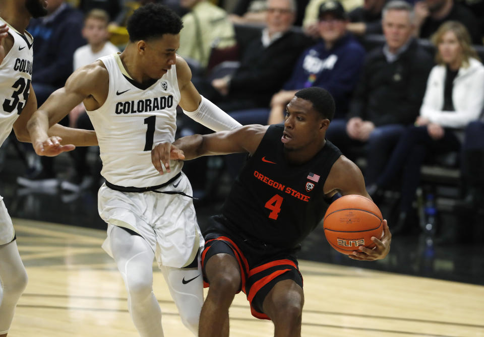 Oregon State forward Alfred Hollins, right, drives to the net as Colorado guard Tyler Bey defends in the first half of an NCAA college basketball game Sunday, Jan. 5, 2020, in Boulder, Colo. (AP Photo/David Zalubowski)