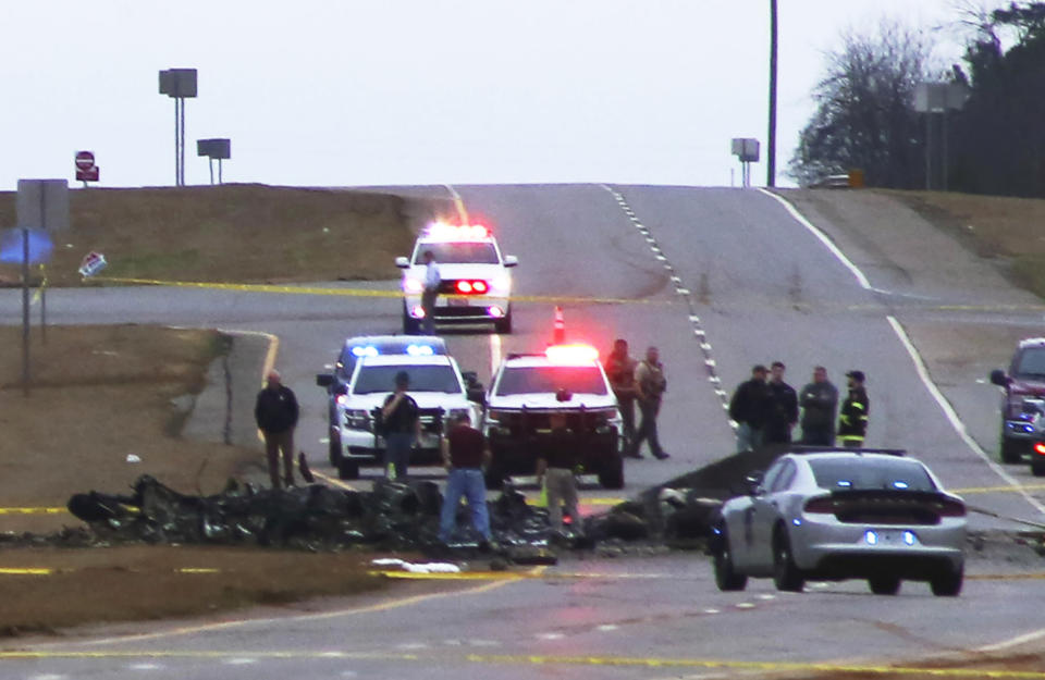 Law enforcement work at the scene of a Black Hawk helicopter crash Wednesday, Feb. 15, 2023, in the unincorporated community of Harvest, Ala. U.S. military officials say two people on board the helicopter, which was from the Tennessee National Guard, were killed. (Chris Montgomery via AP)