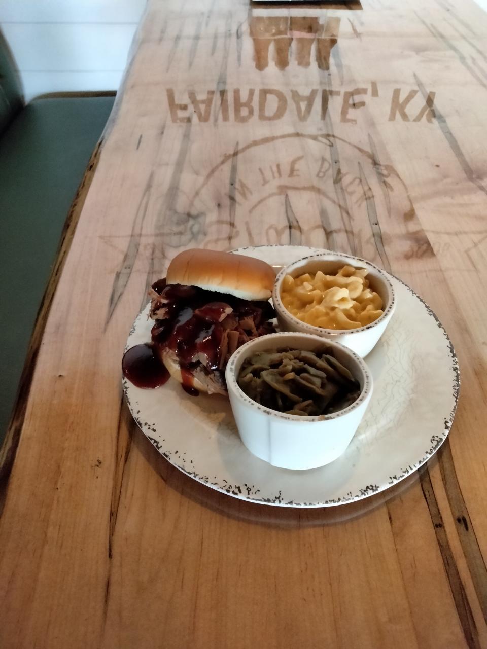 Beef brisket sandwich with green beans and mac n' cheese at Shack in the Back BBQ restaurant in Louisville.