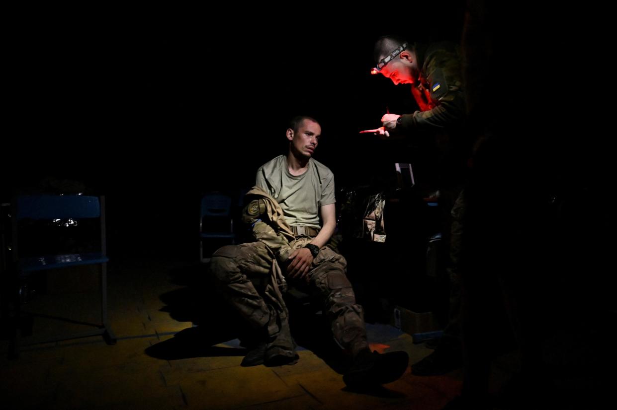 A medic speaks with an injured Ukrainian serviceman inside a frontline medical stabilisation point (REUTERS)