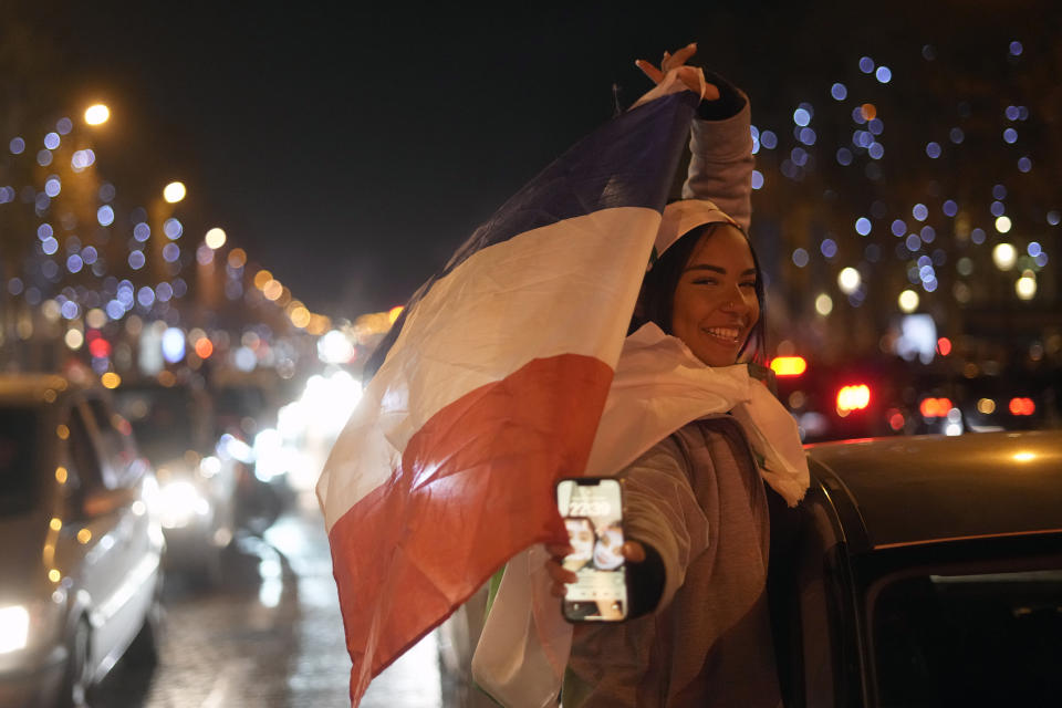 Supporters of France react on the Champs Elysees avenue at the end of the World Cup semifinal soccer match between France and Morocco, in Paris, Wednesday, Dec. 14, 2022. (AP Photo/Thibault Camus)