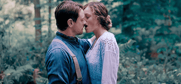 Emma Corrin and Jack O'Connell kiss fervently in the woods in Lady Chatterly's lover