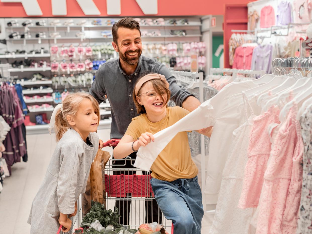 Father with daughters in supermarket