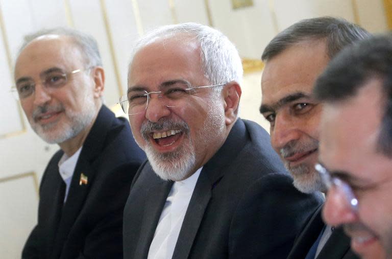 Iranian Foreign Minister Javad Zarif (C) enjoys a lighter moment at the start of a meeting with US Secretary of State (unpictured) in Vienna, Austria, on June 30, 2015