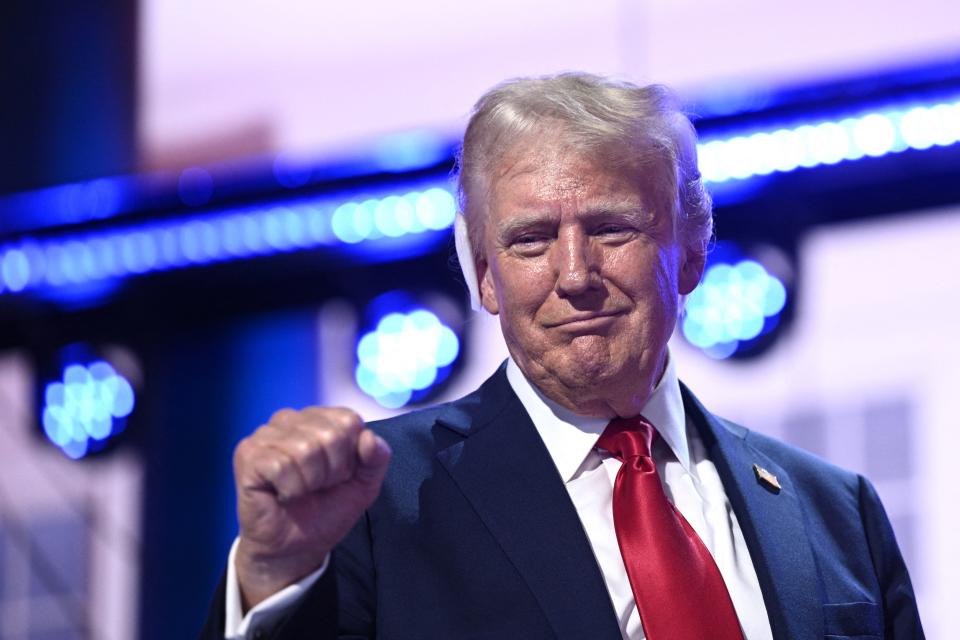 US former President and 2024 Republican presidential candidate Donald Trump holds up a fist onstage during the last day of the 2024 Republican National Convention at the Fiserv Forum in Milwaukee, Wisconsin, on July 18, 2024. Donald Trump will get a hero's welcome Thursday as he accepts the Republican Party's nomination to run for US president in a speech capping a convention dominated by the recent attempt on his life. (Photo by Brendan SMIALOWSKI / AFP) (Photo by BRENDAN SMIALOWSKI/AFP via Getty Images)