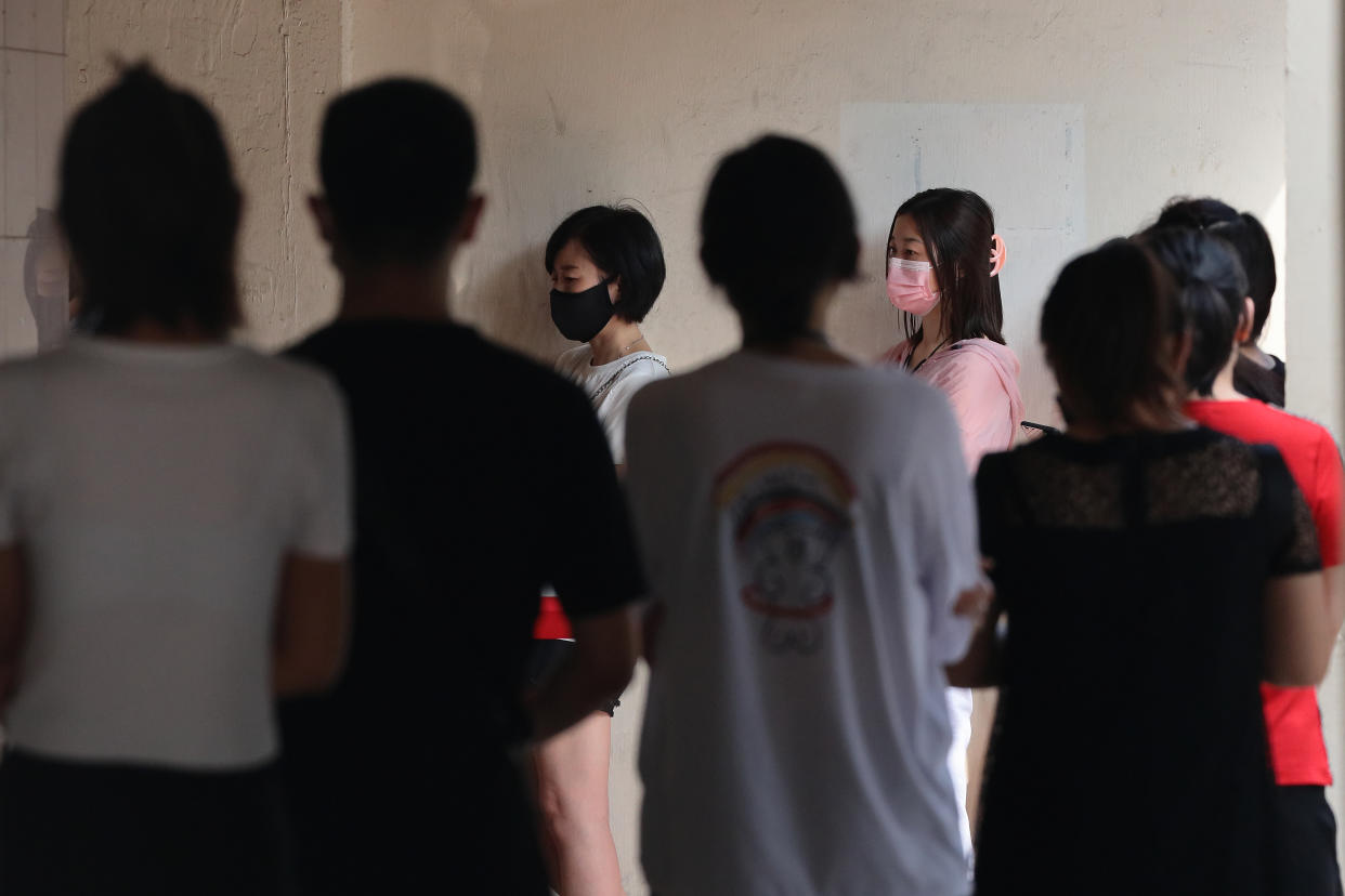 People wait in queue outside a clinic to receive the the China made COVID-19 Sinovac vaccine on June 24, 2021 in Singapore. Singapore allowed the usage of the Sinovac vaccine under the Special Access Route (SAR) framework even though the vaccine remains unregistered and is not authorised by the Health Sciences Authority (HSA). Under the SAR, COVID-19 vaccines approved by the World Health Organisation (WHO) for Emergency Use List (EUL) can be imported and supplied by private healthcare institutions. This will allow individuals an alternative to choose other than the city state approved vaccine, such as Pfzer-BioNTech and Moderna. (Photo by Suhaimi Abdullah/NurPhoto via Getty Images)