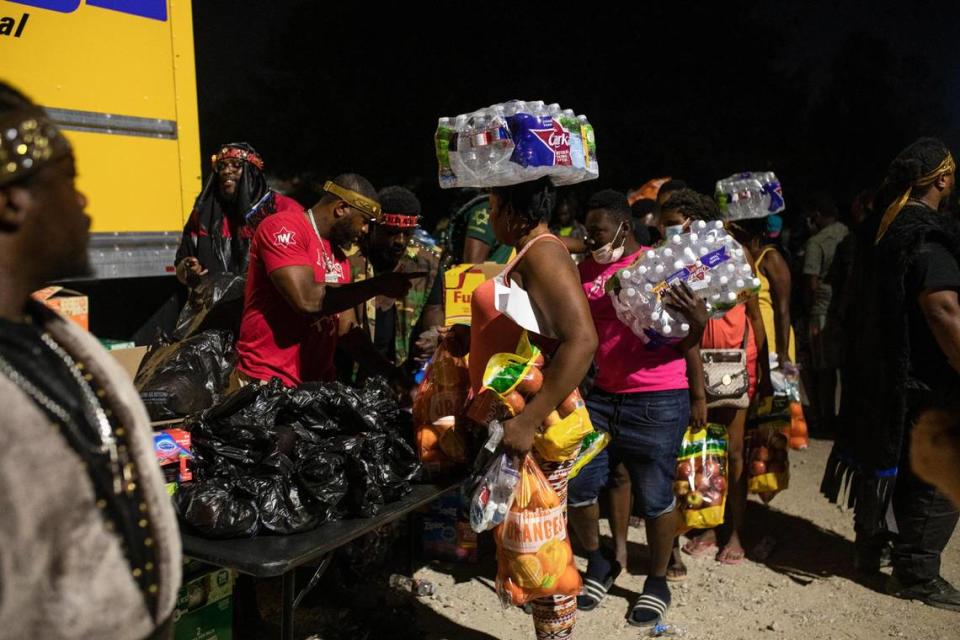 Migrants receive donated food, at dawn in Ciudad Acuña, Mexico, Wednesday, Sept. 22, 2021, near the U.S. border.