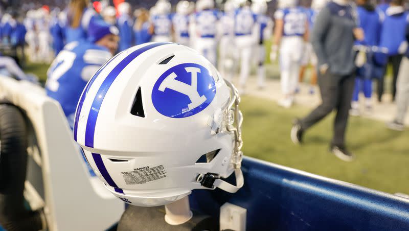 A BYU helmet sits off the sidelines during a game at the LaVell Edwards Stadium field in Provo on Friday, Oct. 28, 2022.