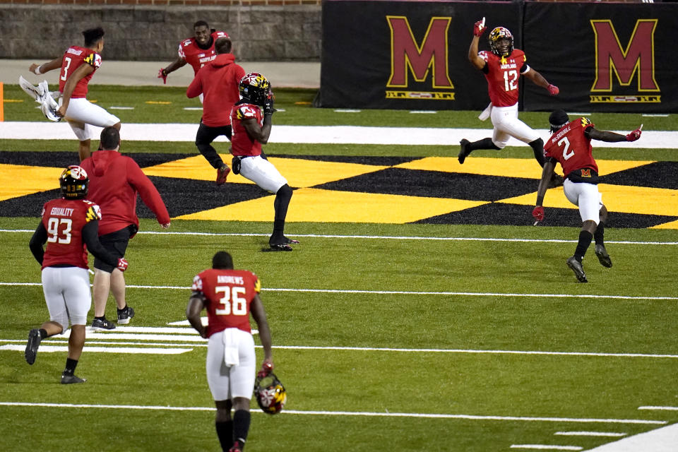 Maryland celebrate after defeating Minnesota during overtime of an NCAA college football game, Friday, Oct. 30, 2020, in College Park, Md. Maryland won 45-44 in overtime. (AP Photo/Julio Cortez)