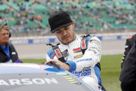 Kyle Larson climbs into his car before a NASCAR Cup Series auto race at Kansas Speedway in Kansas City, Kan., Sunday, May 5, 2024. (AP Photo/Colin E. Braley)