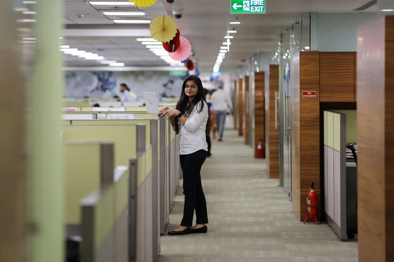 Anjali Verma, 27, an employee with Deloitte, poses for a picture at their office in Gurugram