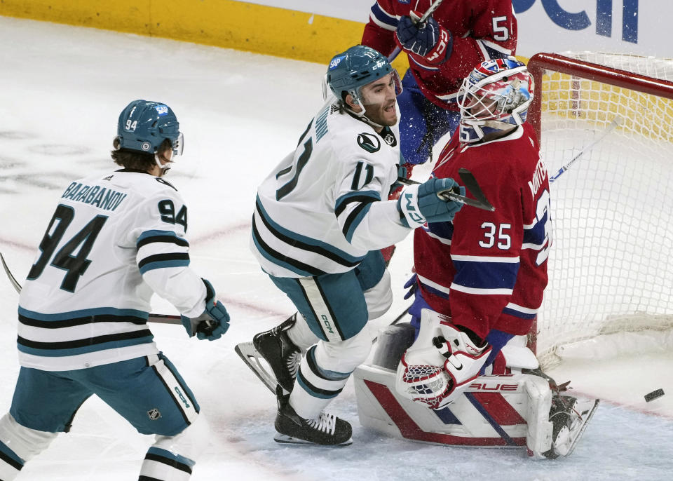 San Jose Sharks' Luke Kunin (11) scores against Montreal Canadiens goaltender Sam Montembeault (35) during first-period NHL hockey game action in Montreal, Thursday, Jan. 11, 2024. (Christinne Muschi/The Canadian Press via AP)