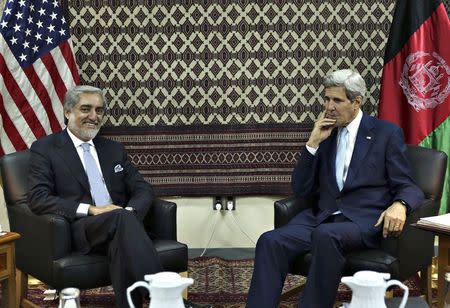 U.S. Secretary of State John Kerry meets with Afghanistan's presidential candidate Abdullah Abdullah (L) during a meeting at U.S. embassy in Kabul August 7, 2014. REUTERS/Massoud Hossaini/Pool