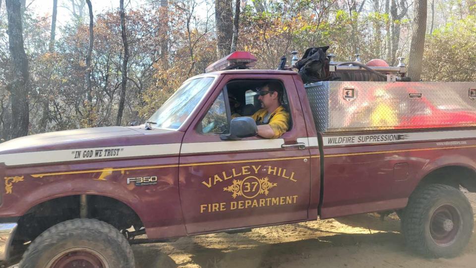 Firefighters from Valley Hill Fire Department make their way up the mountain as they help fight the Poplar Drive Fire on Nov. 8.