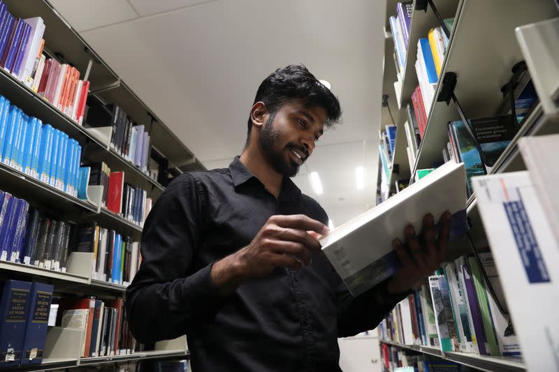 Prathesh Panjak, a first time immigrant voter, reads a book at a library, ahead of Britain's general election, in Manchester