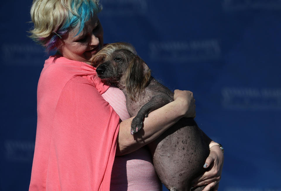 <p>Heather Wilson of Payette, Idaho, clutches her dog Himisaboo. (Justin Sullivan/Getty Images)</p>