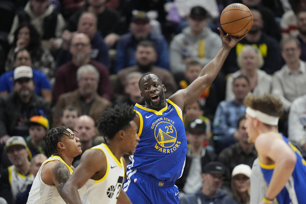 Golden State Warriors forward Draymond Green (23) catches a pass Utah Jazz guard Keyonte George, left, defends during the first half of an NBA basketball game Thursday, Feb. 15, 2024, in Salt Lake City. (AP Photo/Rick Bowmer)