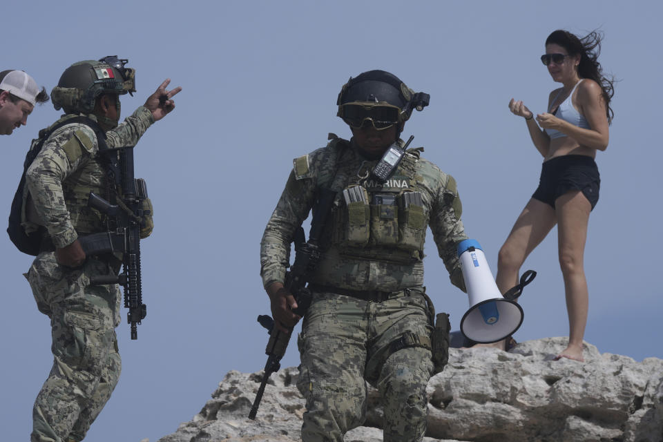 Soldiers ask a tourist to evacuate Mirador beach ahead of Hurricane Beryl's expected arrival in Tulum, Mexico, Thursday, July 4, 2024. (AP Photo/Fernando Llano)