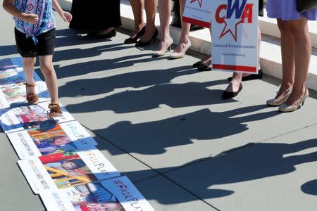 Activists rally outside U.S. Supreme Court after the Court sided with Trinity Lutheran Church, which objected to being denied public money in Missouri, in Washington, U.S., June 26, 2017. REUTERS/Yuri Gripas