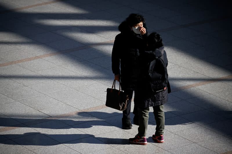 Women wearing masks talk at a railway station amid the coronavirus disease (COVID-19) pandemic in Seoul