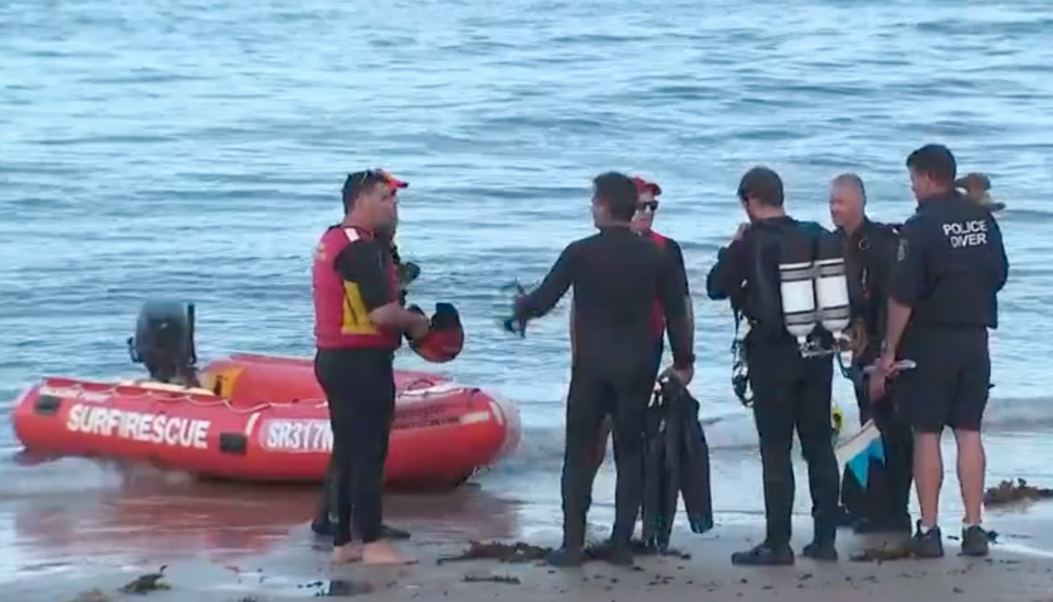 Police divers and surf lifesavers during the search operation at Shelly Beach. Source: 7 News