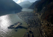 This aerial photo shows plastic bottles, wooden planks, rusty barrels and other garbage clogging the Drina river near the eastern Bosnian town of Visegrad, Bosnia, Tuesday, Jan. 5, 2021. Further upstream, the Drina tributaries in Montenegro, Serbia and Bosnia are carrying even more waste after the swollen rivers surged over the the landfills by their banks. The Balkan nations have poor waste management and tons of garbage routinely end up in rivers. (AP Photo/Eldar Emric)