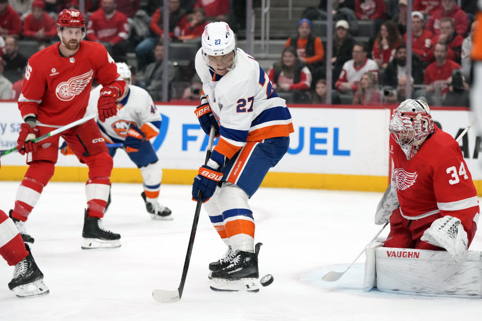 Detroit Red Wings goaltender Alex Lyon (34) stops a shot by New York Islanders left wing Anders Lee (27) during the first period of an NHL hockey game, Thursday, Feb. 29, 2024, in Detroit. (AP Photo/Carlos Osorio)