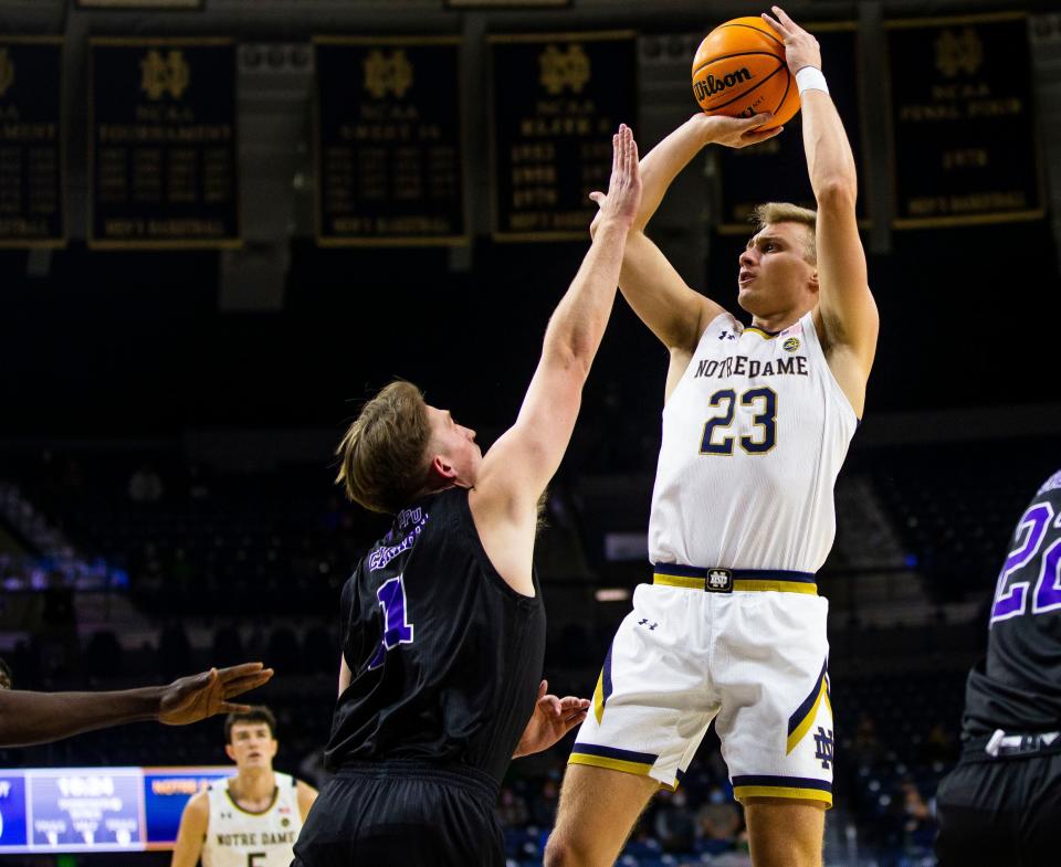 Notre Dame's Dane Goodwin (23) shoots over High Point's John-Michael Wright (1) during the Notre Dame vs. High Point NCAA men's basketball game Tuesday, Nov. 16, 2021 at Purcell Pavilion in South Bend. 