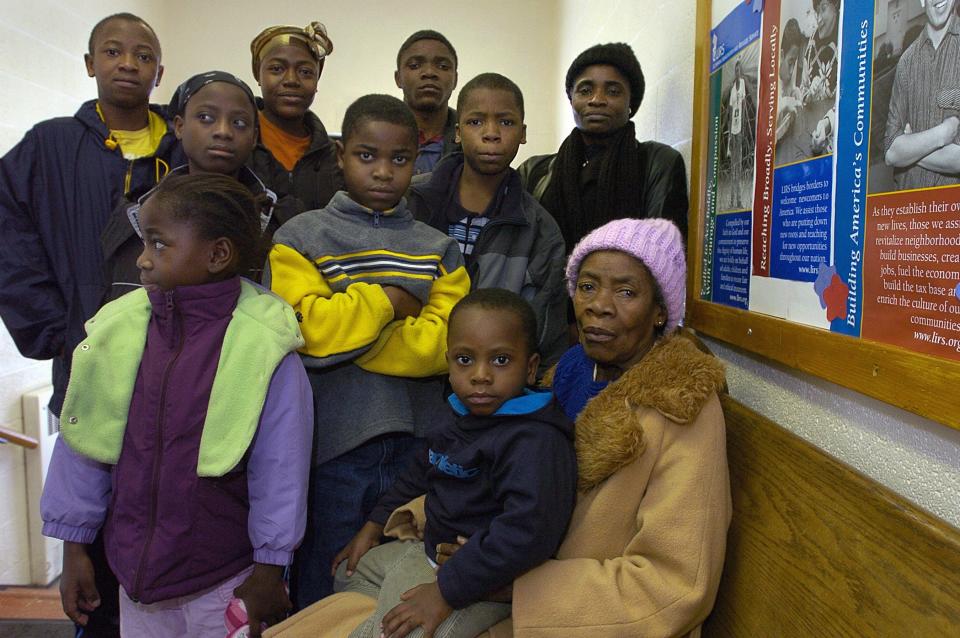 The large, extended Blamo family from war-torn Liberia poses after church at Christ Lutheran Church in Lansing in 2005. Top row, from left, are Kanrwea Blamo, 11, March Blamo, 14, Weah Blamo, 19, and Orena Blamo. Middle Row, Agnes Blamo, 9, Ba Blamo, 7, and Bob Blamo, 12. Bottom row are Edith Blamo, 5, Try Blamo, 2, and Nancy Blamo. Ba has grown up to be a star running back on the Grand Ledge football team.