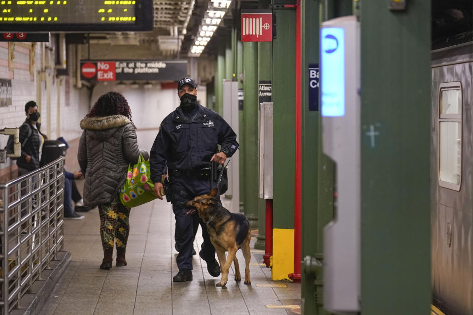 Police officers patrol a subway station in New York, Tuesday, April 12, 2022. Multiple people were shot and injured Tuesday at a subway station in New York City during a morning rush hour attack that left wounded commuters bleeding on a train platform. (AP Photo/Seth Wenig)