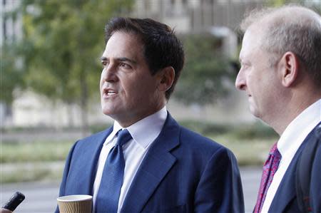 Mark Cuban (L), the billionaire owner of the NBA's Dallas Mavericks, speaks with the media while his attorney Stephen Best (R) looks on prior to entering U.S District Court for the opening day of his insider trading trial in Dallas, Texas September 30, 2013. REUTERS/Tim Sharp