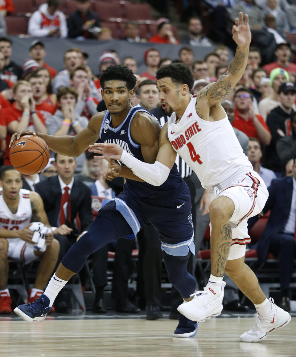 Villanova's Jermaine Samuels, left, tries to dribble past Ohio State's Duane Washington during the first half of an NCAA college basketball game Wednesday, Nov. 13, 2019, in Columbus, Ohio. (AP Photo/Jay LaPrete)