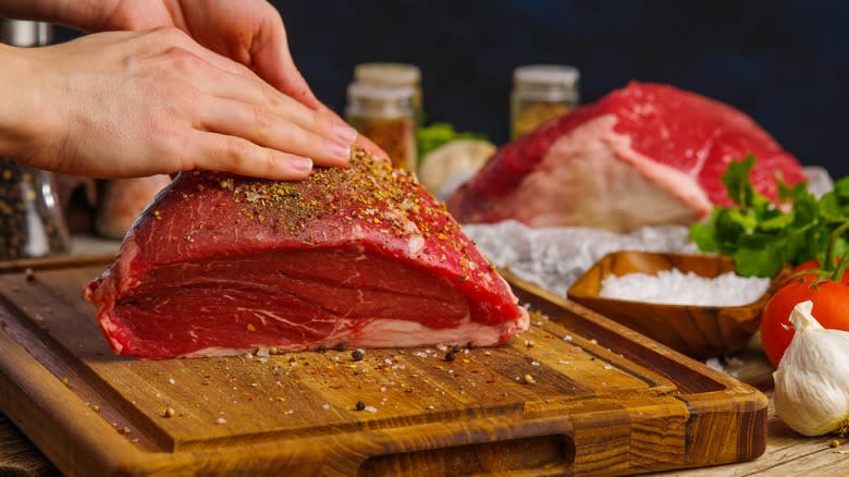 rubbing spices on beef