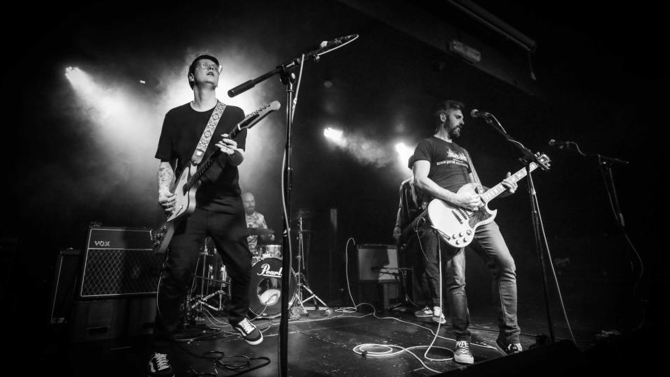 Black and white photo of Dinosaur Death Pose on stage