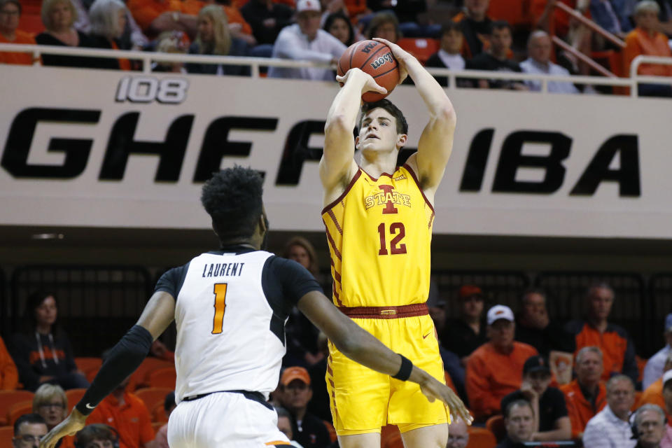 Iowa State forward Michael Jacobson (12) shoots over Oklahoma State guard Jonathan Laurent (1) in the second half of an NCAA college basketball game in Stillwater, Okla., Saturday, Feb. 29, 2020. (AP Photo/Sue Ogrocki)