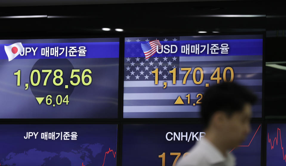 A currency trader stands by the screens showing the foreign exchange rates at the foreign exchange dealing room in Seoul, South Korea, Monday, July 8, 2019. Asian stocks tumbled Monday after relatively strong U.S. employment data tempered hopes the Federal Reserve might cut interest rates. (AP Photo/Lee Jin-man)