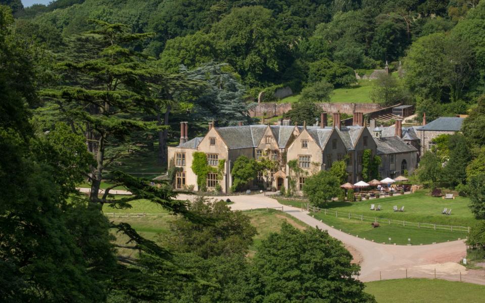 country house surrounded by green and trees