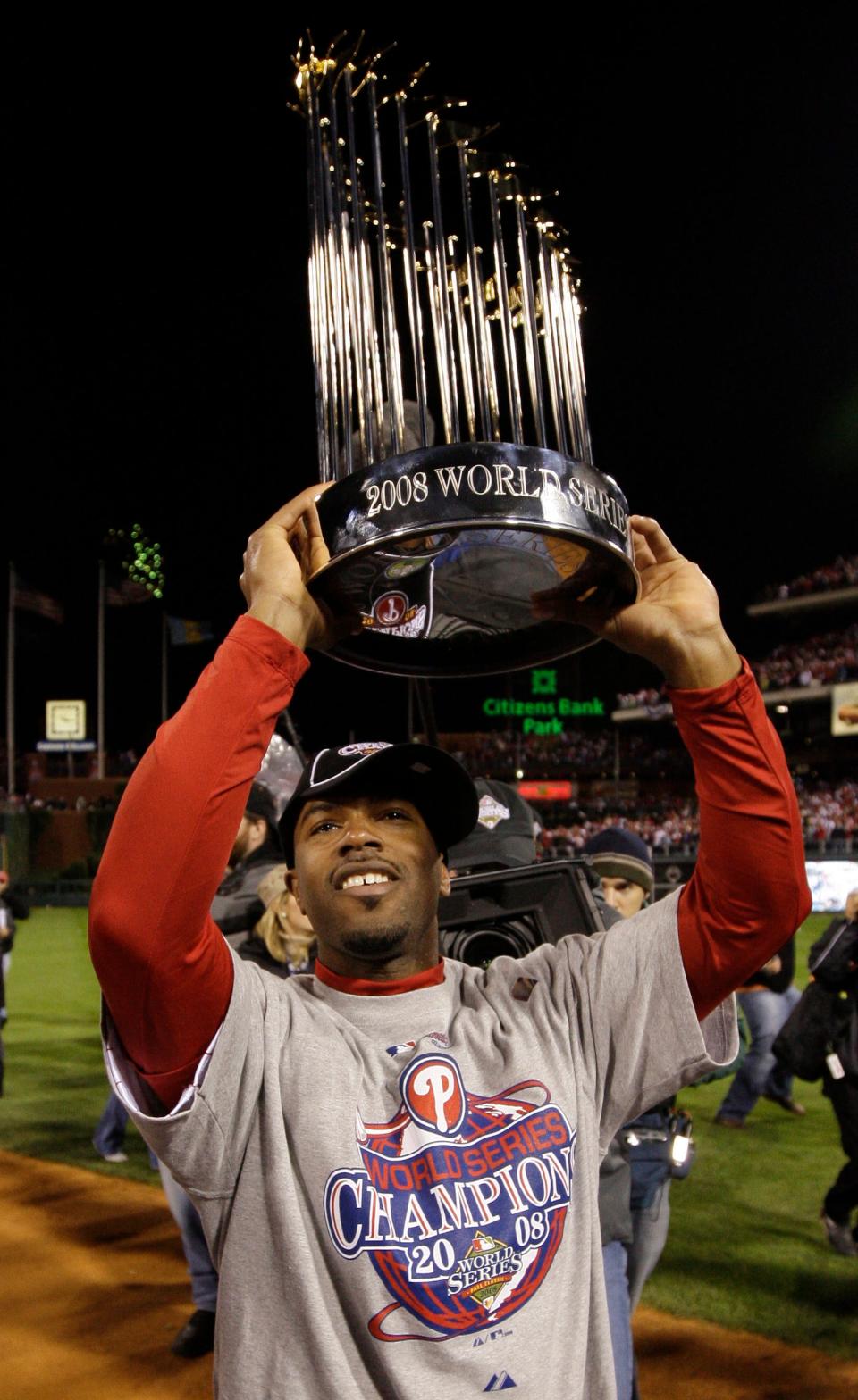 Philadelphia Phillies' Jimmy Rollins holds up the World Series trophy after Game 5 of the baseball World Series.