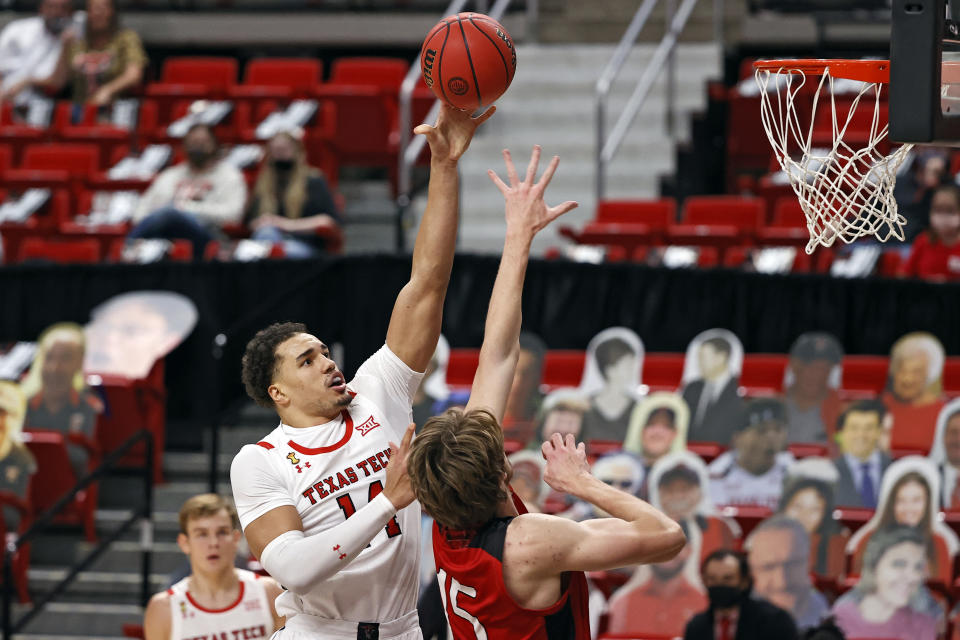 Texas Tech's Marcus Santos-Silva (14) shoots over Incarnate Word's Marcus Larsson (15) during the first half of an NCAA college basketball game Tuesday, Dec. 29, 2020, in Lubbock, Texas. (AP Photo/Brad Tollefson)