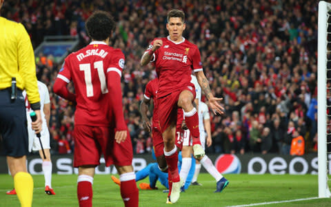 Roberto Firmino celebrates with Salah after scoring Liverpool's fourth goal against Roma - Credit: Getty Images