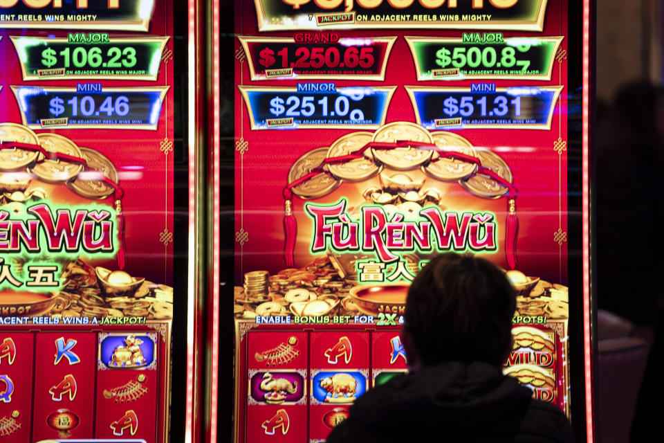 A patron of The Rivers Casino in Portsmouth, Va., plays on one of the several varieties of games during the casino's grand opening, Jan. 23, 2023. With casinos popping up on Virginia's southern border, some lawmakers now want to explore whether wealthy northern Virginia should get in on the action. (Billy Schuerman/The Virginian-Pilot via AP)