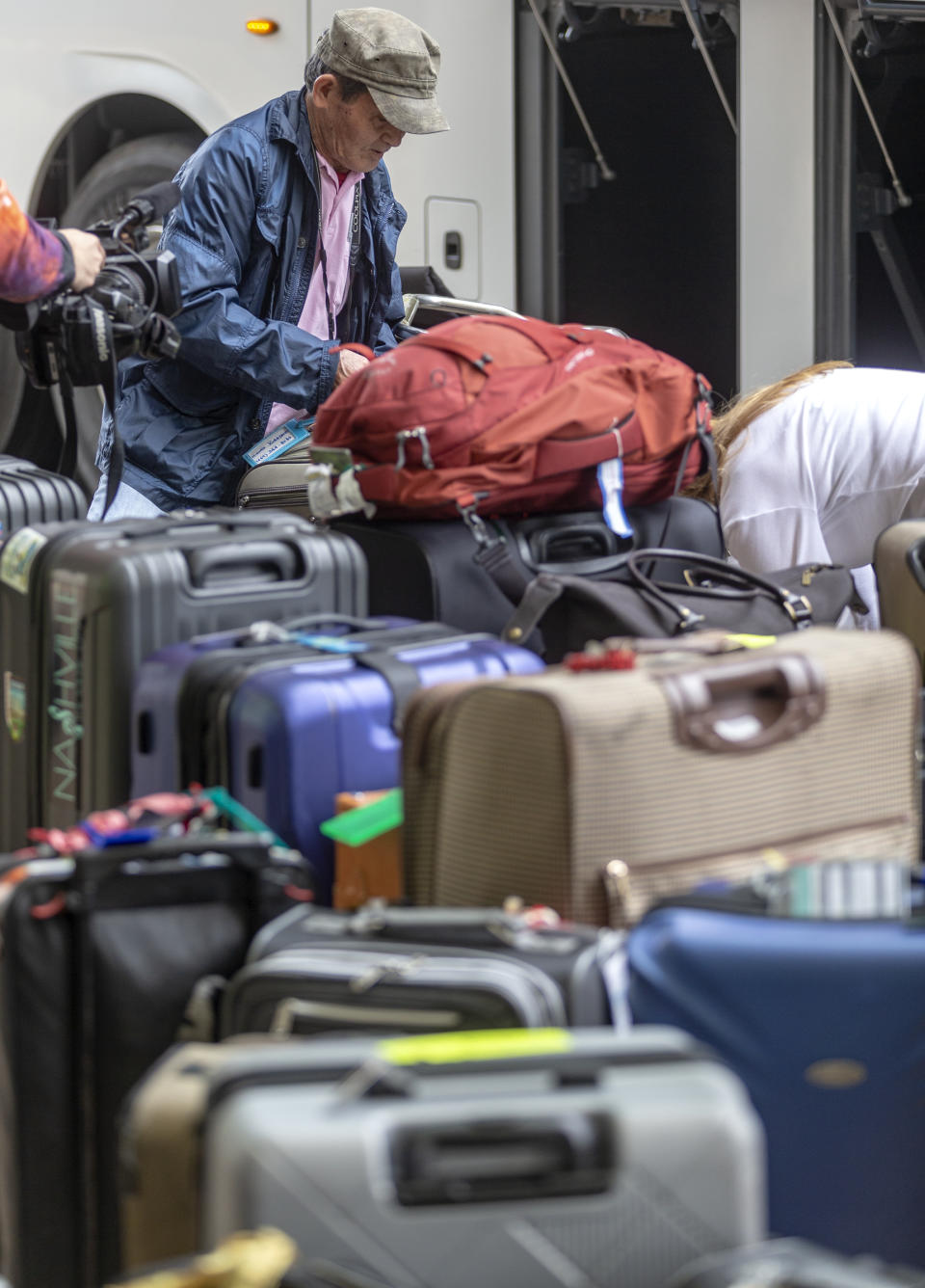 People arrive at the San Antonio International Airport Tuesday, March 3, 2020 after being released from quarantine at JBSA-Lackland. The people were evacuated from the coronavirus-infected Diamond Princess cruise ship in Japan and had been held in quarantine at Lackland to ensure they were not infected with the virus. (William Luther/The San Antonio Express-News via AP)