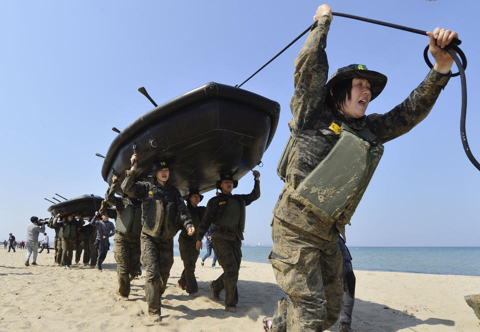 Members of the women's South Korean national handball team perform a team-building exercise with rubber boats during physical training at a boot camp for the Marine Corps in Pohang, South Korea, on March 30, 2016. (Choe Dong-joon/Newsis via AP)