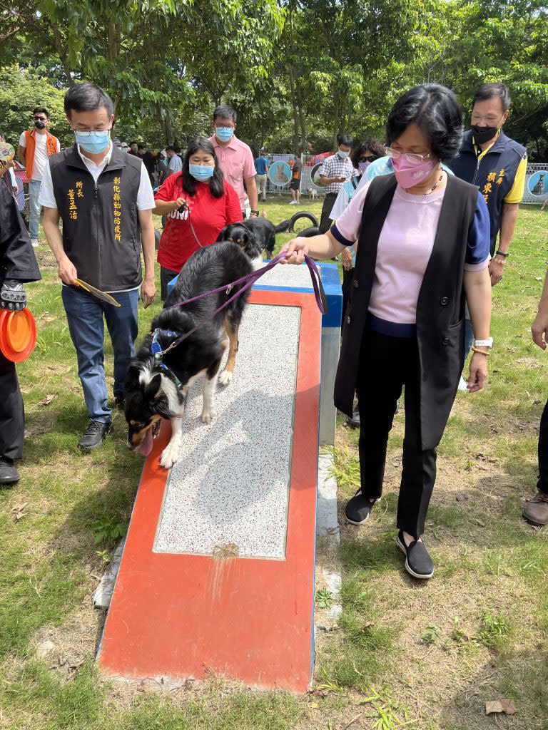 彰化縣長王惠美牽著狗狗溜滑梯。（記者吳東興攝）