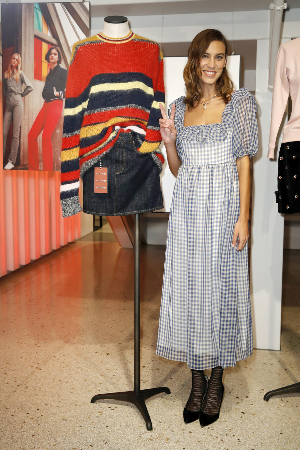 <p>The fashion designer wore a gingham blue smock dress for the UZwei store opening in Hamburg, Germany</p>