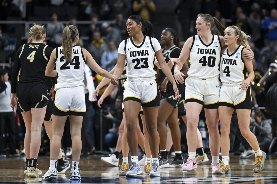 Iowa players celebrate after defeating Colorado in a Sweet Sixteen round college basketball game during the NCAA Tournament, Saturday, March 30, 2024, in Albany, N.Y. (AP Photo/Hans Pennink)