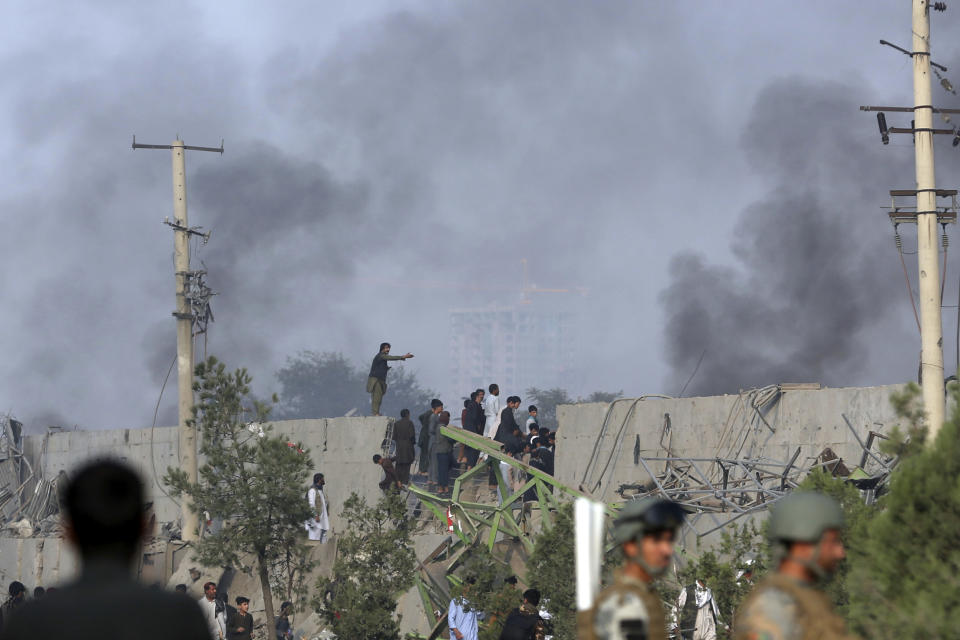 ADDS DATE - Smoke rises as angry Kabul residents set fire to part of the Green Village compound that has been attacked frequently, a day after a Taliban suicide attack in Kabul, Tuesday, Sept. 3, 2019. An interior ministry spokesman said some hundreds of foreigners were rescued after the attack targeted the compound, which houses several international organizations and guesthouses. (AP Photo/Rahmat Gul)