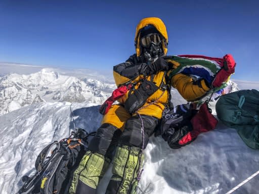 Saray Khumalo poses with a South African flag on May 16, 2019, after becoming the first black African woman to climb Mount Everest